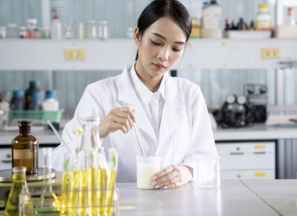 Expert perfumer developing a new perfume formula using aromatic ingredients.