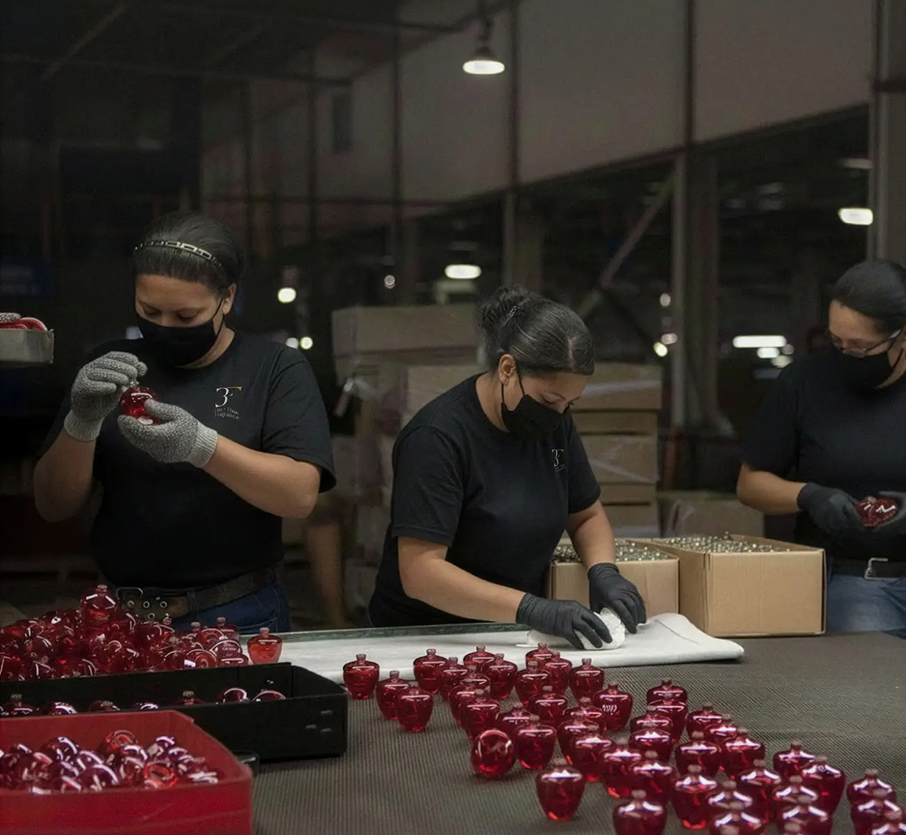 Perfume manufacturing team in UAE reviewing custom bottle designs and packaging samples, representing bespoke private label and bulk production solutions for international fragrance brands.